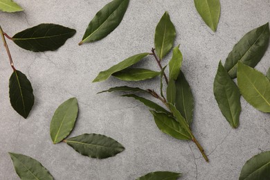 Photo of Aromatic bay leaves on light gray table, flat lay