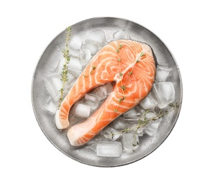 Plate with fresh raw salmon steak and ice cubes on white background, top view