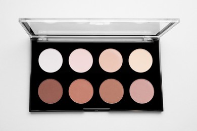 Photo of Colorful contouring palette on light grey background, top view. Professional cosmetic product