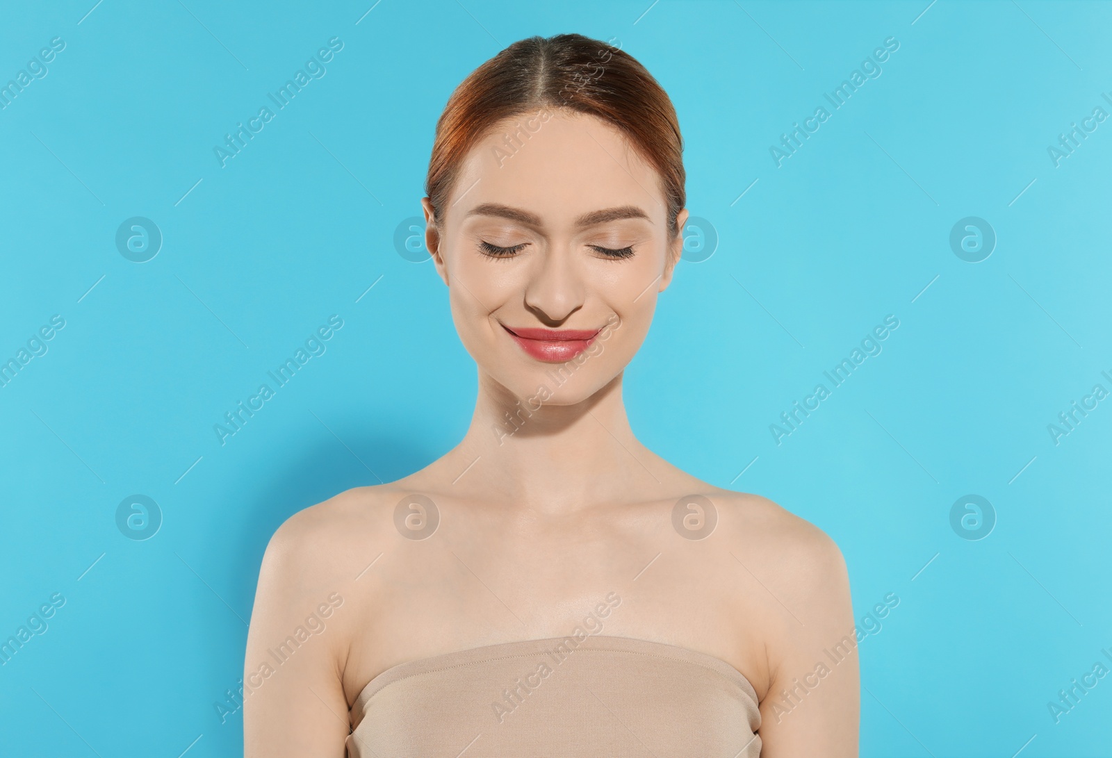 Photo of Beautiful young woman on light blue background