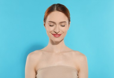 Photo of Beautiful young woman on light blue background