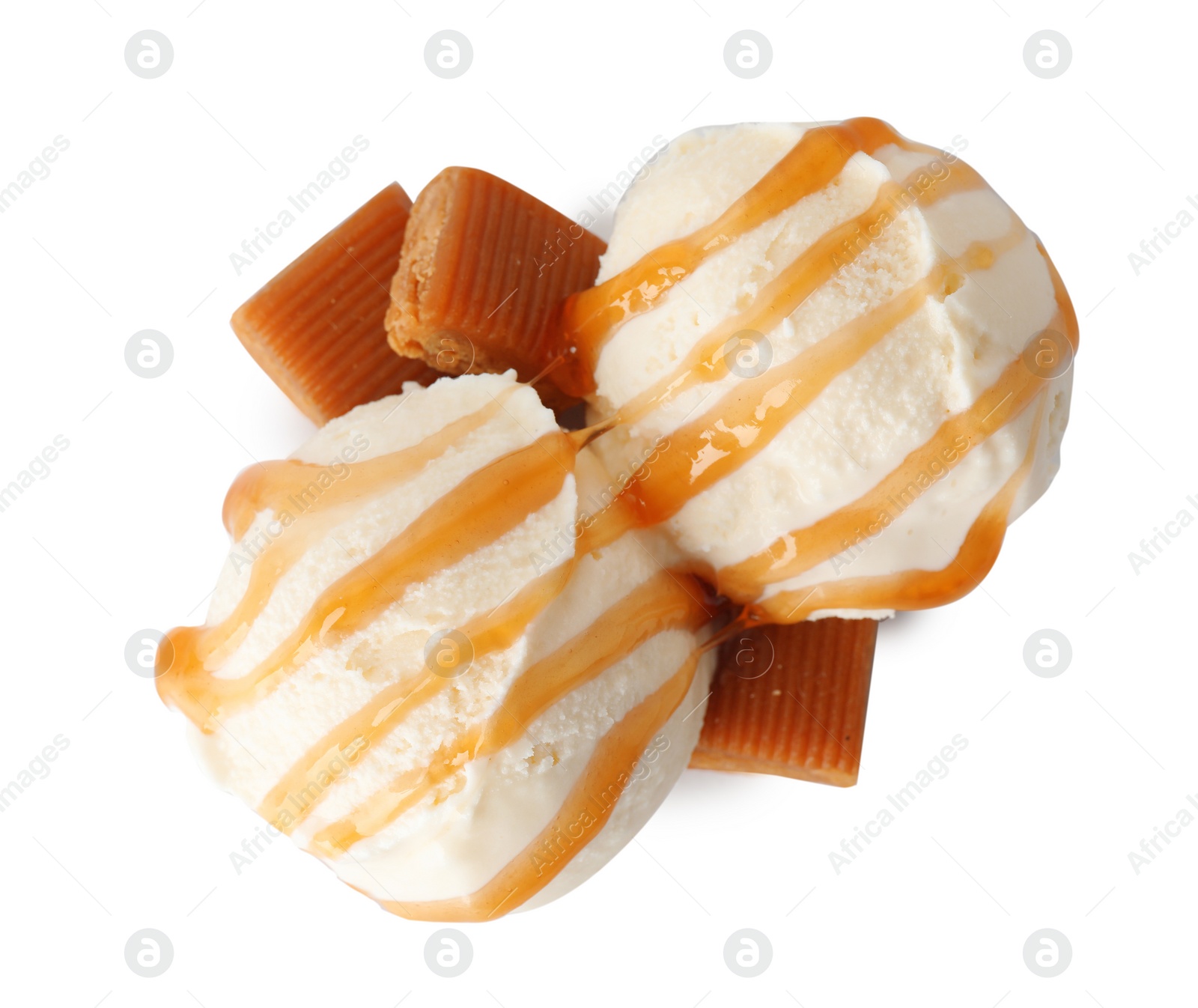 Photo of Scoops of delicious ice cream with caramel sauce and candies on white background, top view