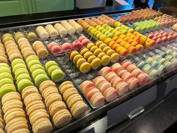 Showcase with different delicious sweet macarons in store