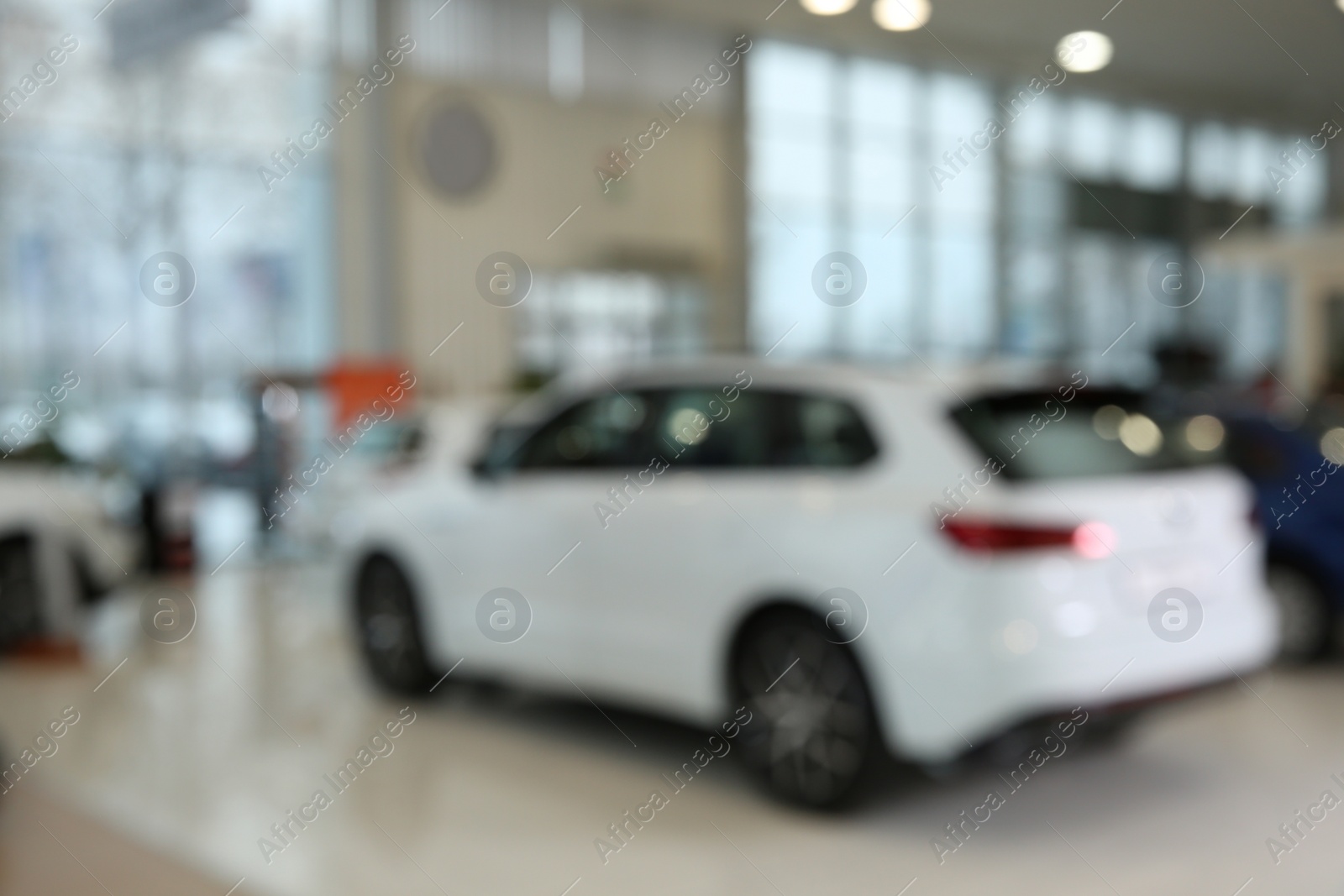 Photo of Blurred view of large car dealership interior