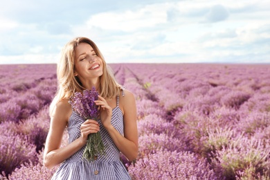 Photo of Young woman with bouquet in lavender field