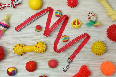 Photo of Flat lay composition with pet leash and toys on white wooden background