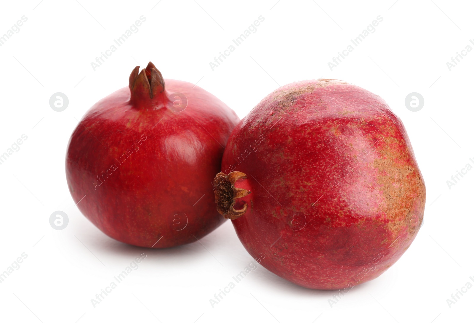 Photo of Ripe pomegranates on white background. Delicious fruits