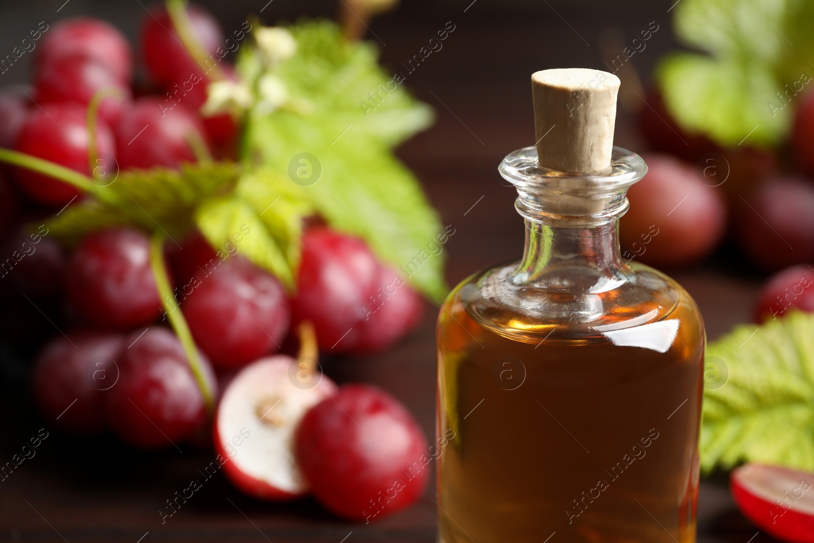 Photo of Bottle of natural grape seed oil, closeup. Organic cosmetic