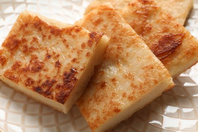 Photo of Delicious turnip cake on plate, closeup view
