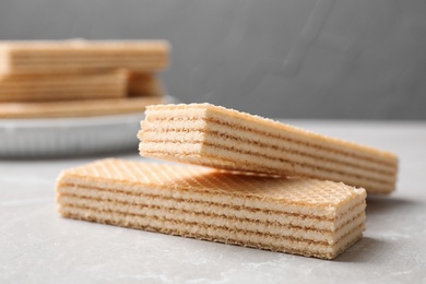 Photo of Delicious cream wafers on light grey marble table, closeup