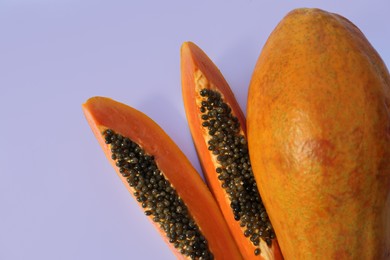 Photo of Fresh ripe cut and whole papaya fruits on white background, flat lay. Space for text