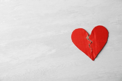 Photo of Torn cardboard heart on gray background, top view with space for text. Relationship problems