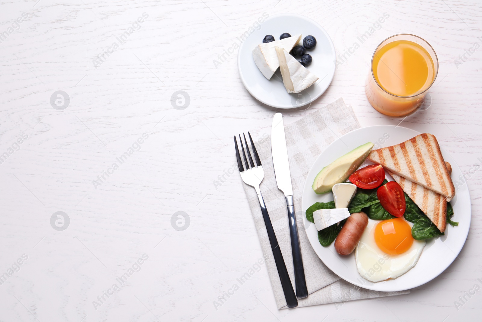 Photo of Delicious breakfast with fried egg served on white wooden table, flat lay. Space for text