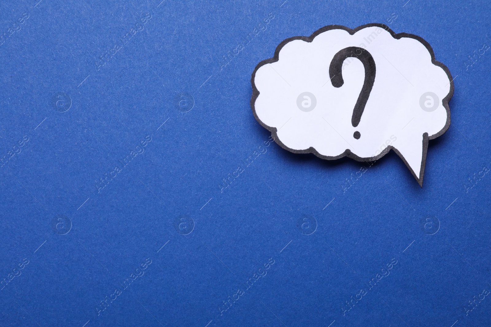 Photo of Paper speech bubble with question mark on blue background, top view. Space for text