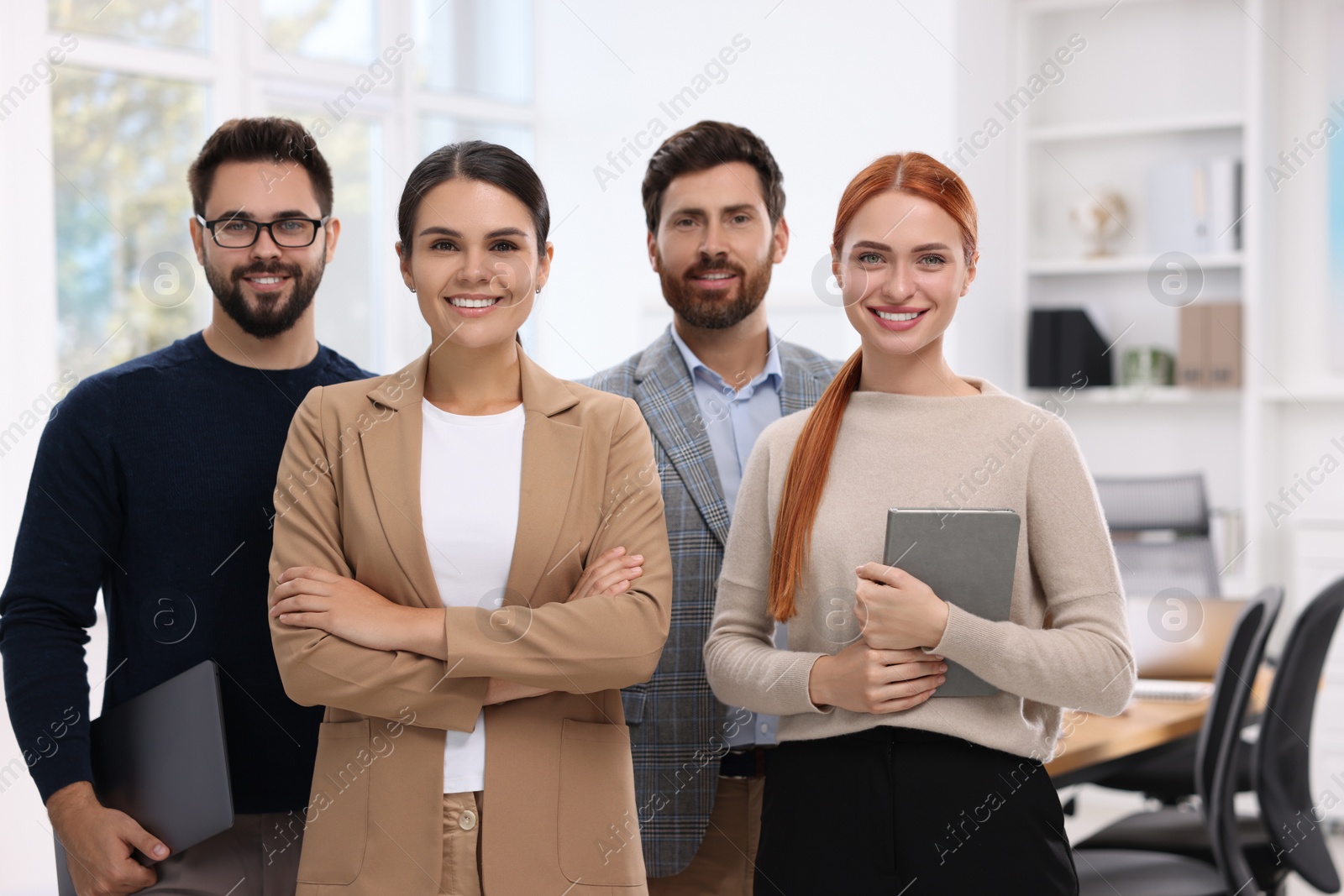 Photo of Portrait of happy employees in office. Team work