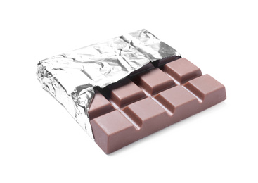 Delicious milk chocolate bar wrapped in foil isolated on white