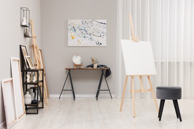 Photo of Artist's studio with easels, canvases and painting supplies
