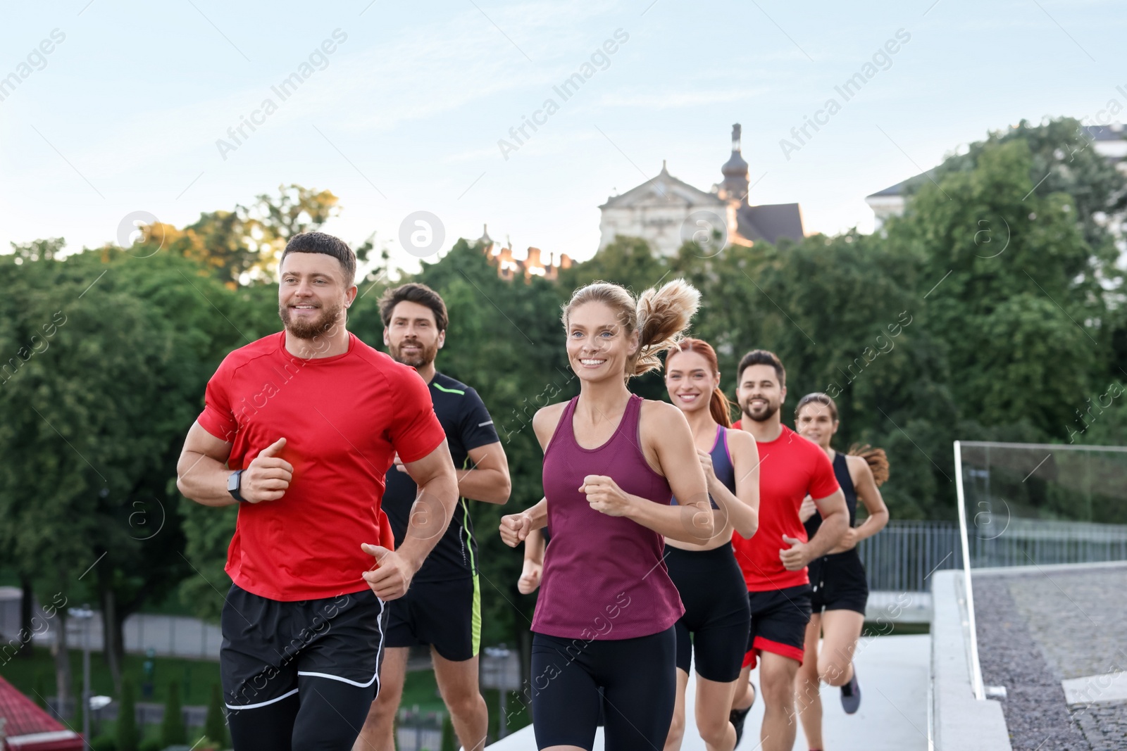 Photo of Group of people running outdoors. Active lifestyle