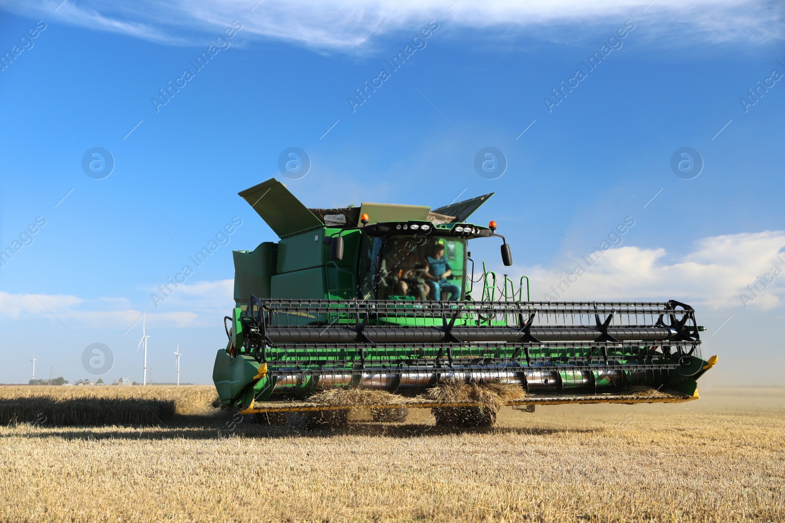 Photo of Modern combine harvester working in agricultural field