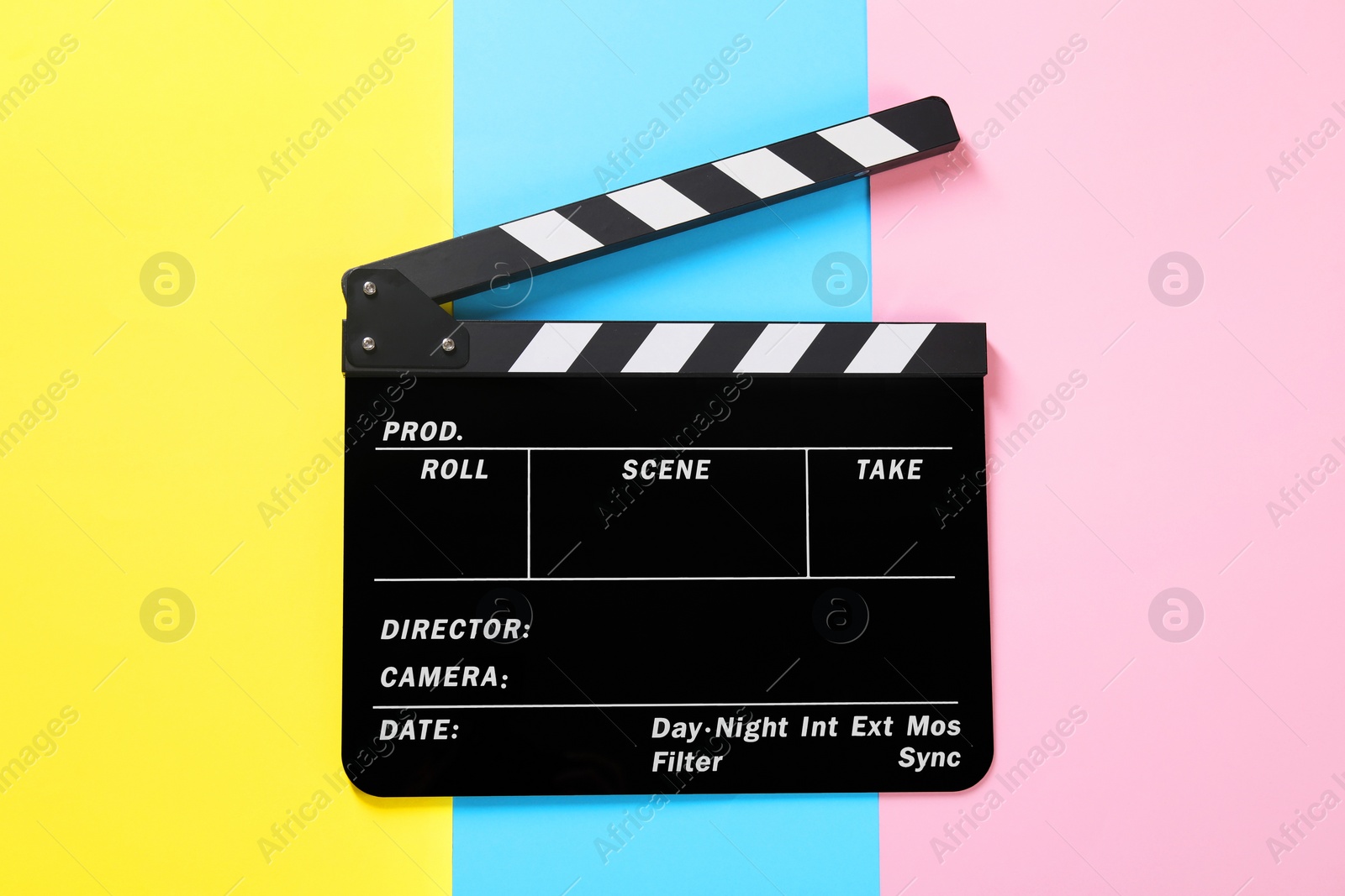 Photo of Clapperboard on color background, top view. Film industry