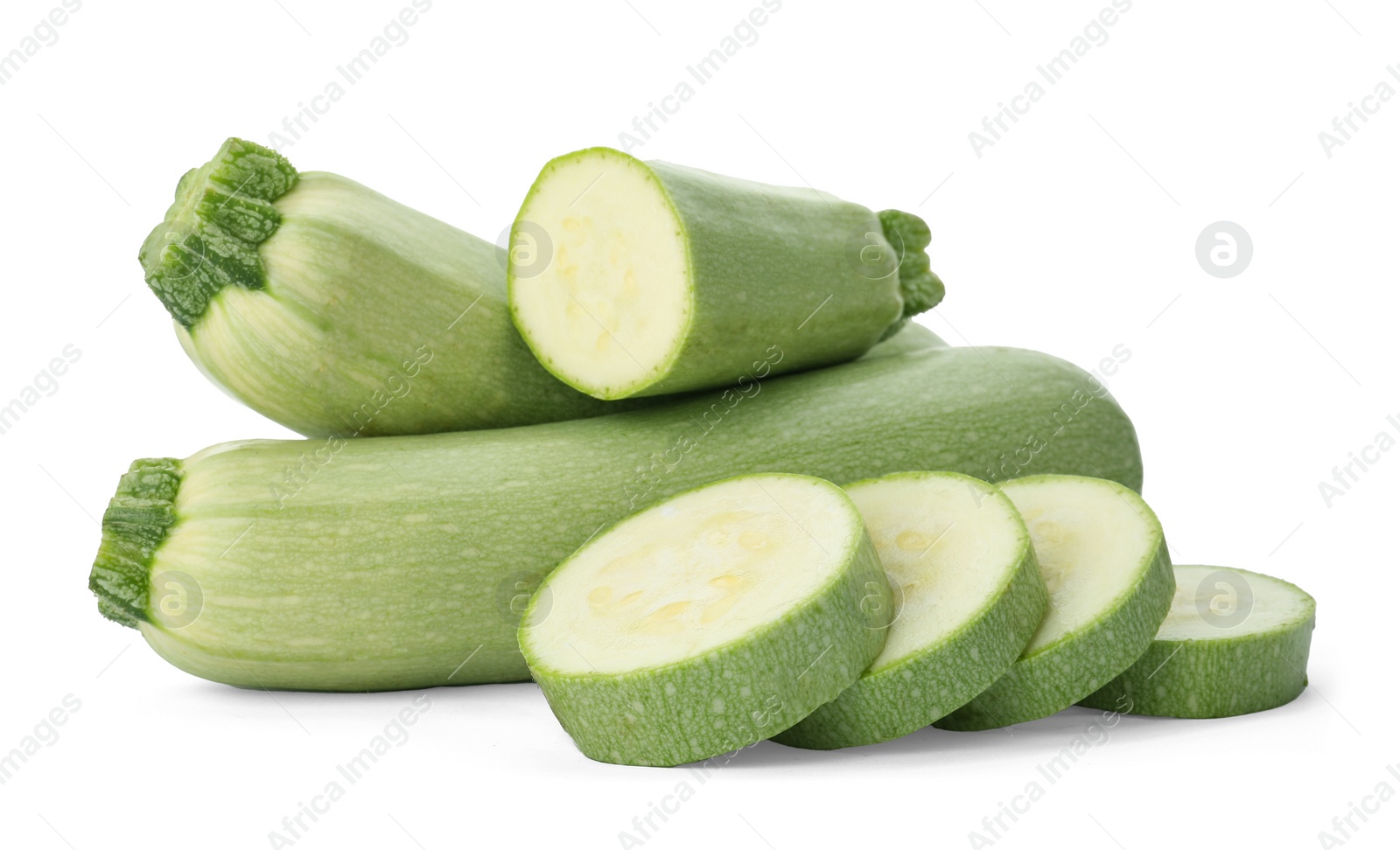 Photo of Cut and whole green ripe zucchinis on white background