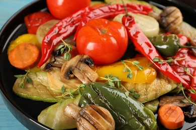 Delicious grilled vegetables on black plate, closeup