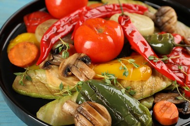 Photo of Delicious grilled vegetables on black plate, closeup