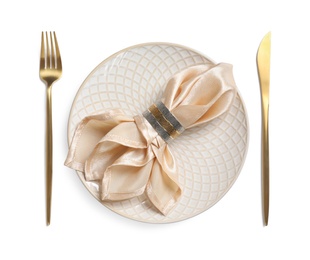 Beautiful table setting with golden cutlery and beige napkin on white background, top view