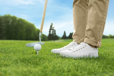 Photo of Person playing golf on green course, closeup