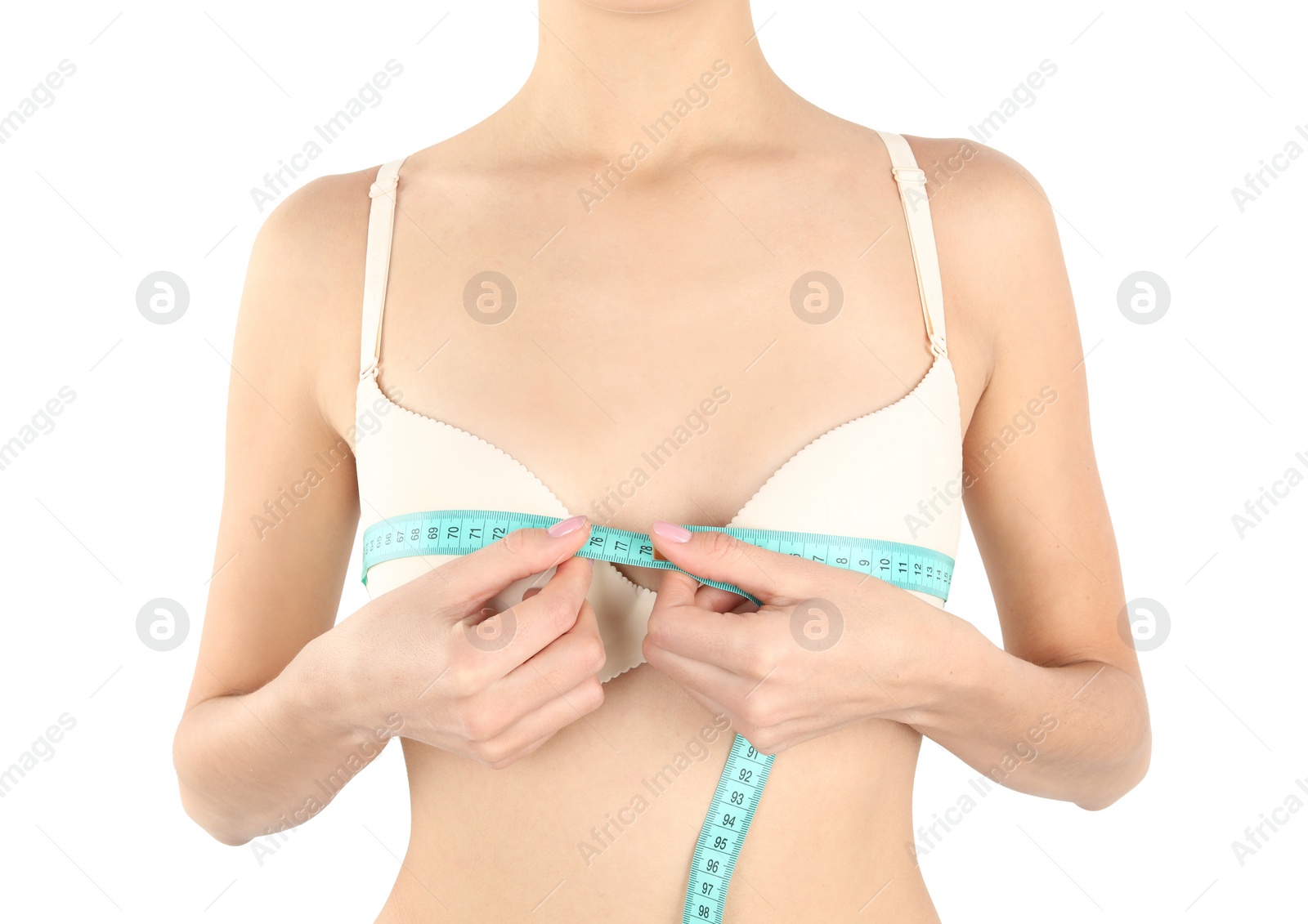 Photo of Young woman measuring breast size on white background, closeup. Cosmetic surgery