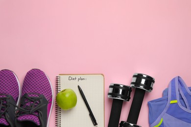 Photo of Weight loss concept. Flat lay composition with sneakers, fitness items and notebook on pink background, space for text