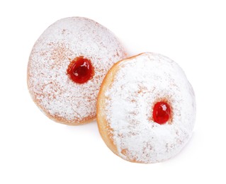 Delicious donuts with jelly and powdered sugar on white background, top view