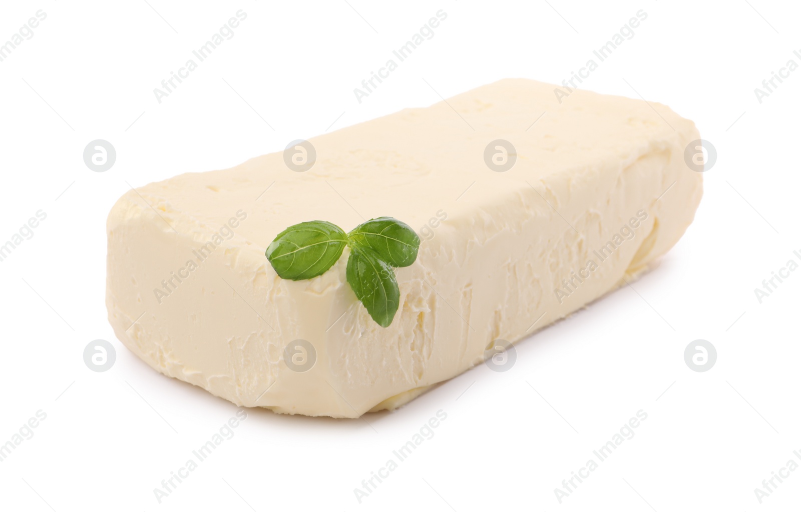 Photo of Block of tasty butter with basil isolated on white