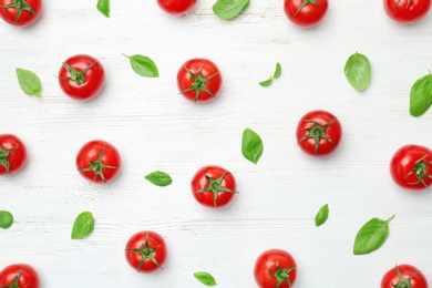 Flat lay composition with ripe tomatoes on wooden background