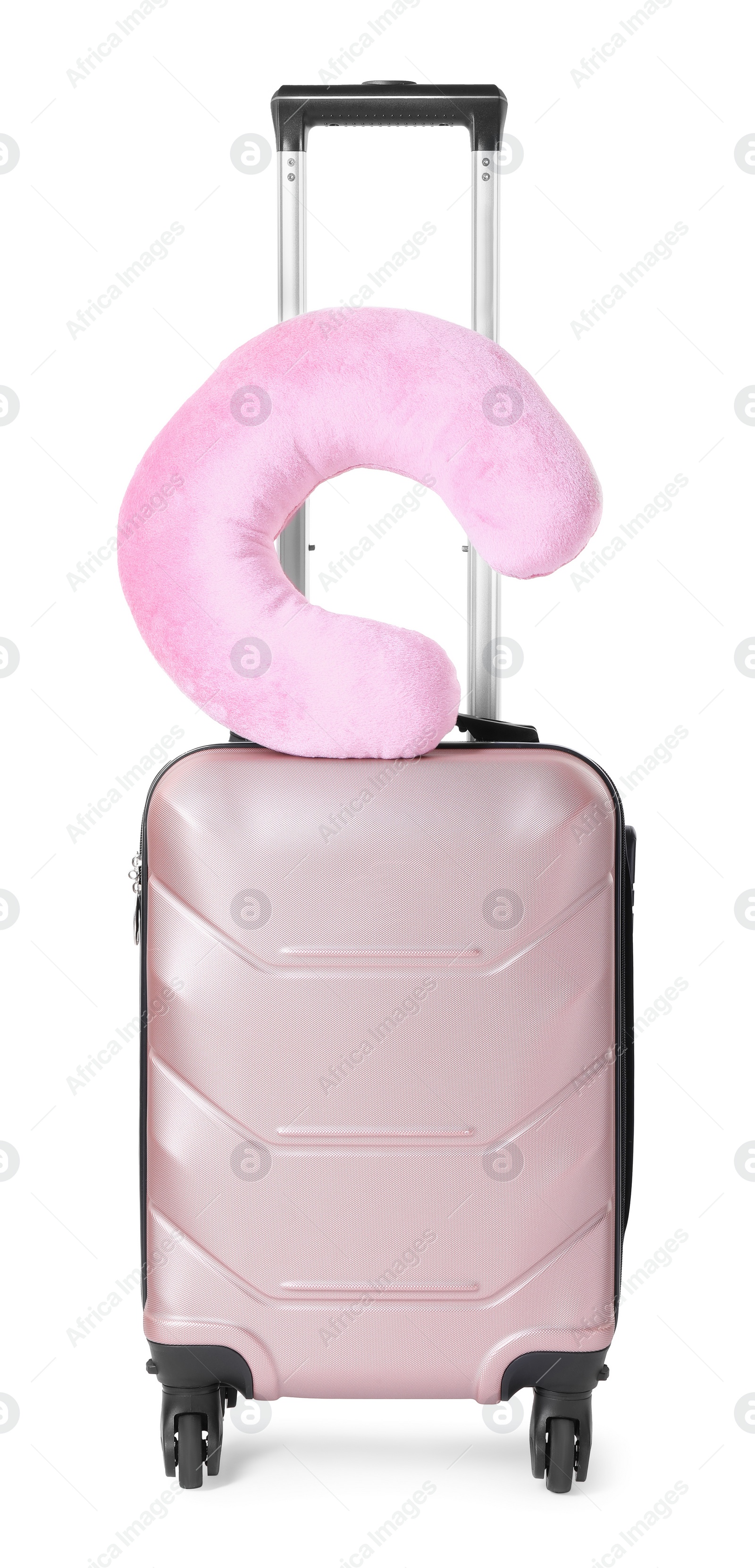 Photo of Pink travel pillow on suitcase against white background