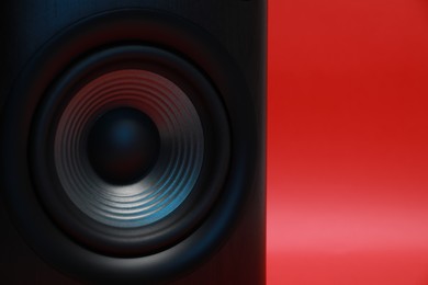 Photo of One wooden sound speaker on red background, closeup. Space for text