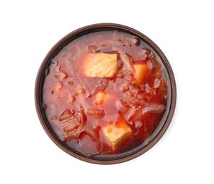 Bowl of delicious borscht isolated on white, top view