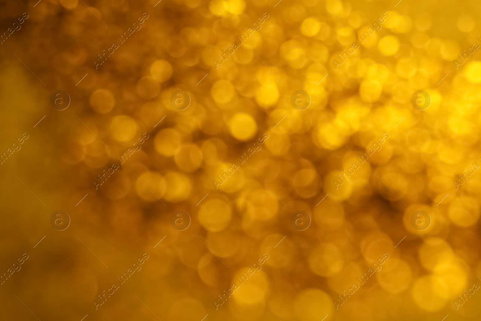 Photo of Blurred view of golden lights as background. Bokeh effect