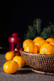 Ripe tangerines on wooden table against dark background. Christmas celebration