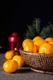 Photo of Ripe tangerines on wooden table against dark background. Christmas celebration