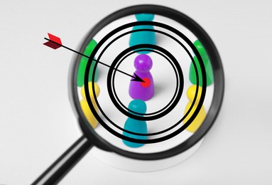 Image of Arrow aiming to pawn, view through magnifying glass with target. White background