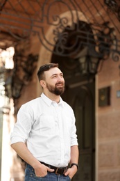 Portrait of young businessman in stylish outfit outdoors