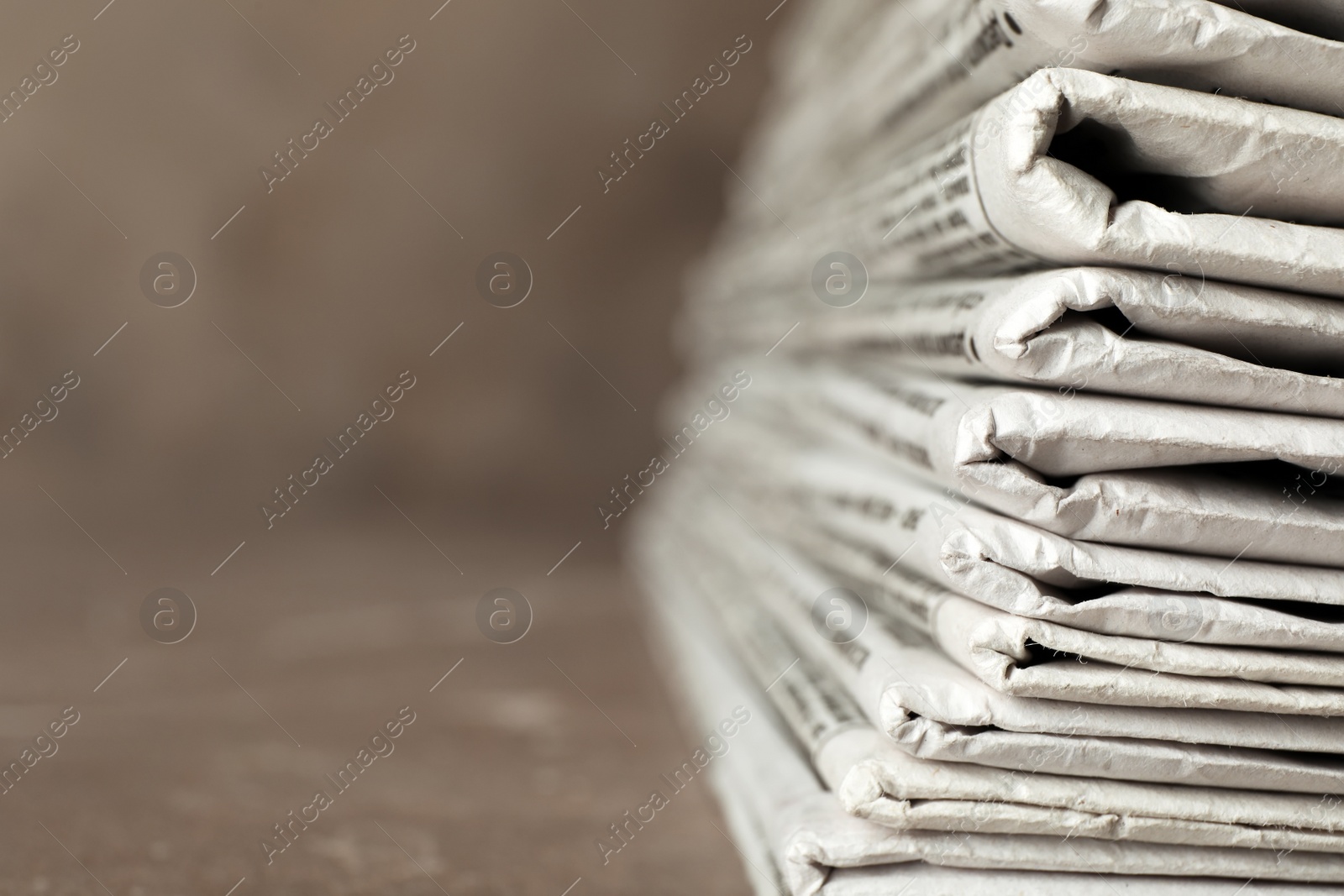 Photo of Stack of newspapers on table, closeup with space for text. Journalist's work