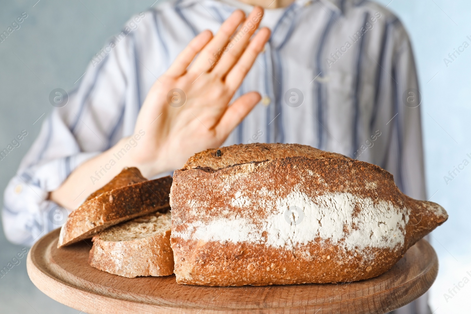 Photo of Woman refusing to eat bread, closeup. Food allergy concept