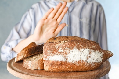 Photo of Woman refusing to eat bread, closeup. Food allergy concept