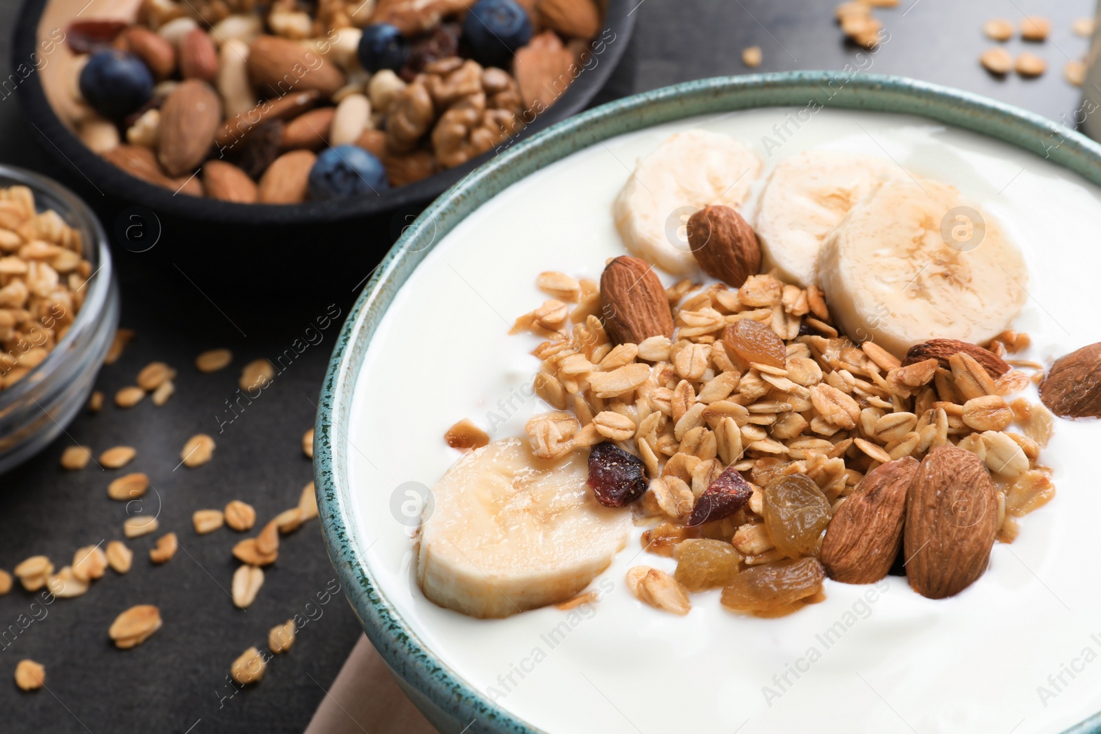 Photo of Bowl with yogurt, banana and granola, closeup