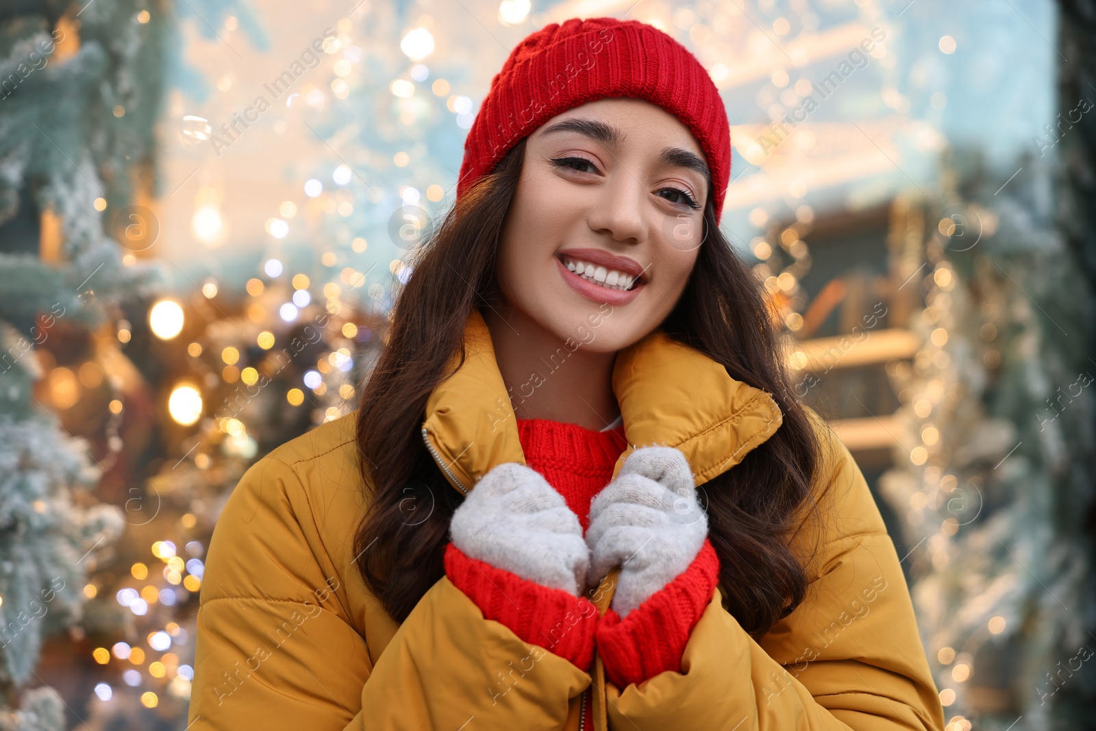 Photo of Portrait of smiling woman on blurred background. Winter time