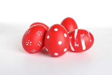 Creative painted red Easter eggs on white background