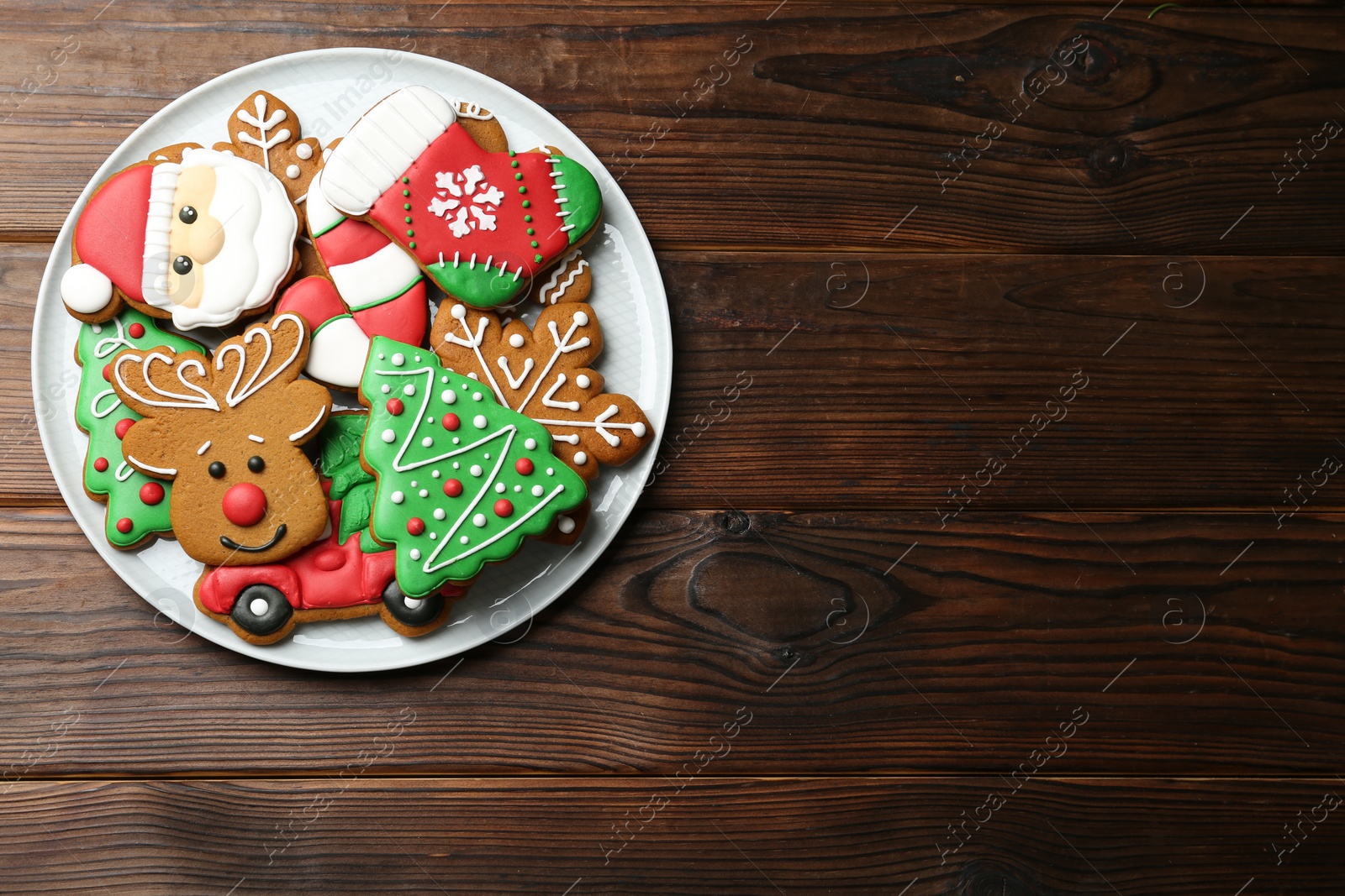 Photo of Different tasty Christmas cookies on wooden table, top view. Space for text