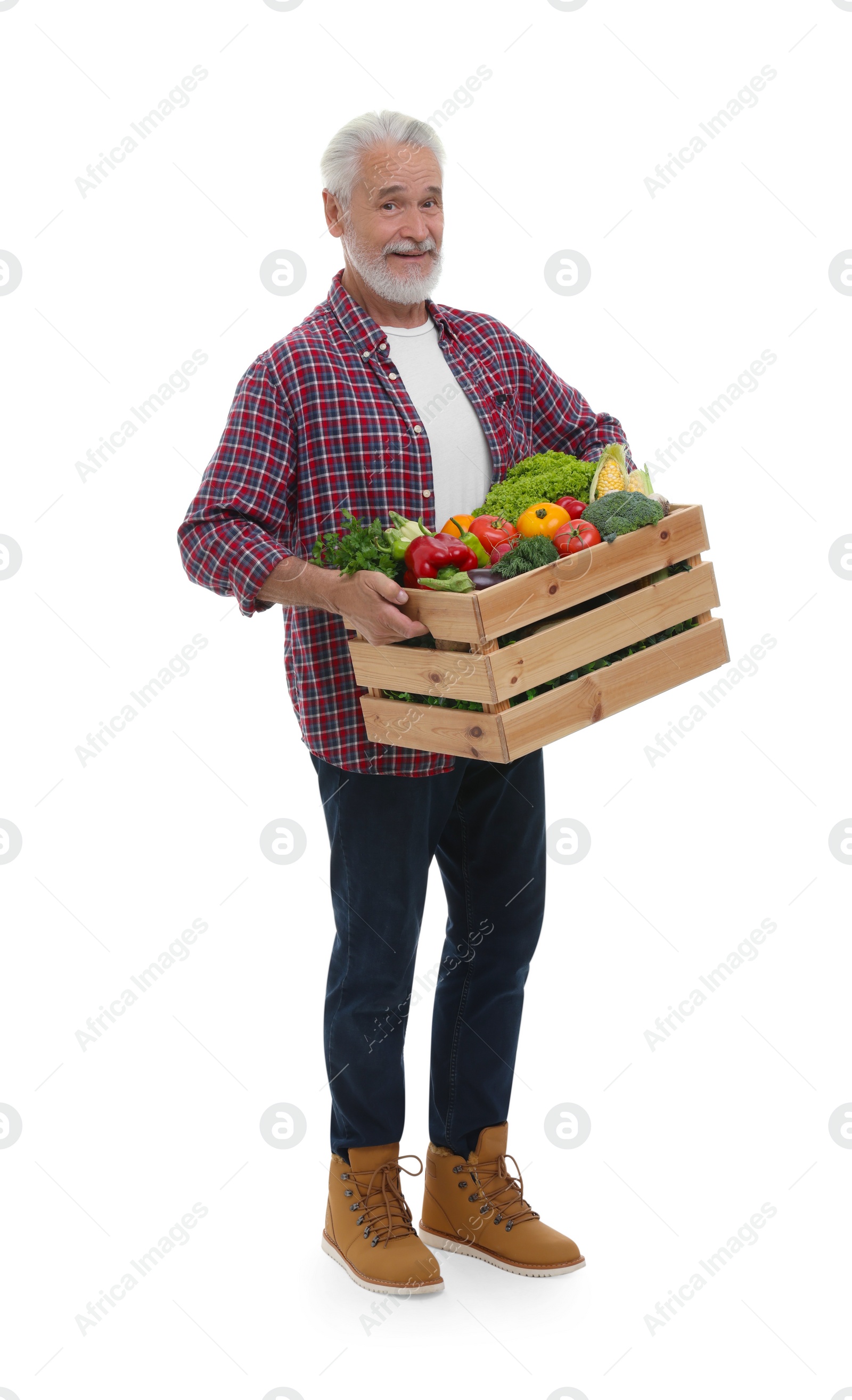 Photo of Harvesting season. Happy farmer holding wooden crate with vegetables on white background